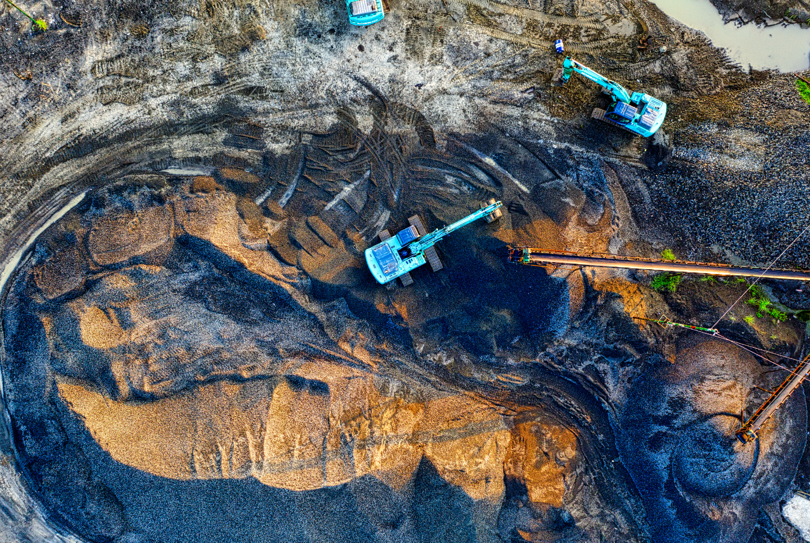 Open-pit mining operation with heavy equipment and field personnel using reliable communications technologies to support connected mining operations.